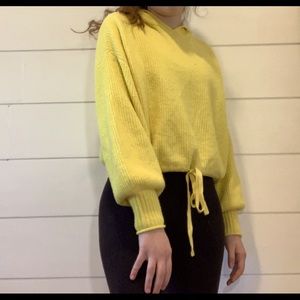 yellow sweater in cropped hoodie style